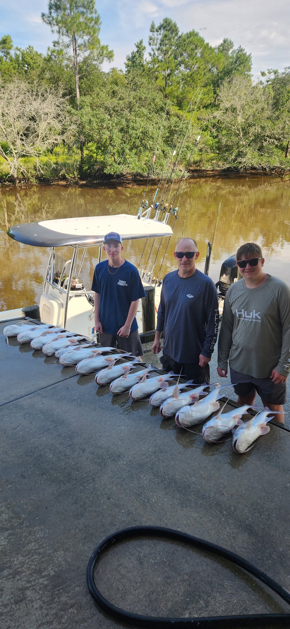 Three people enjoying a fishing trip in Gulf Shores