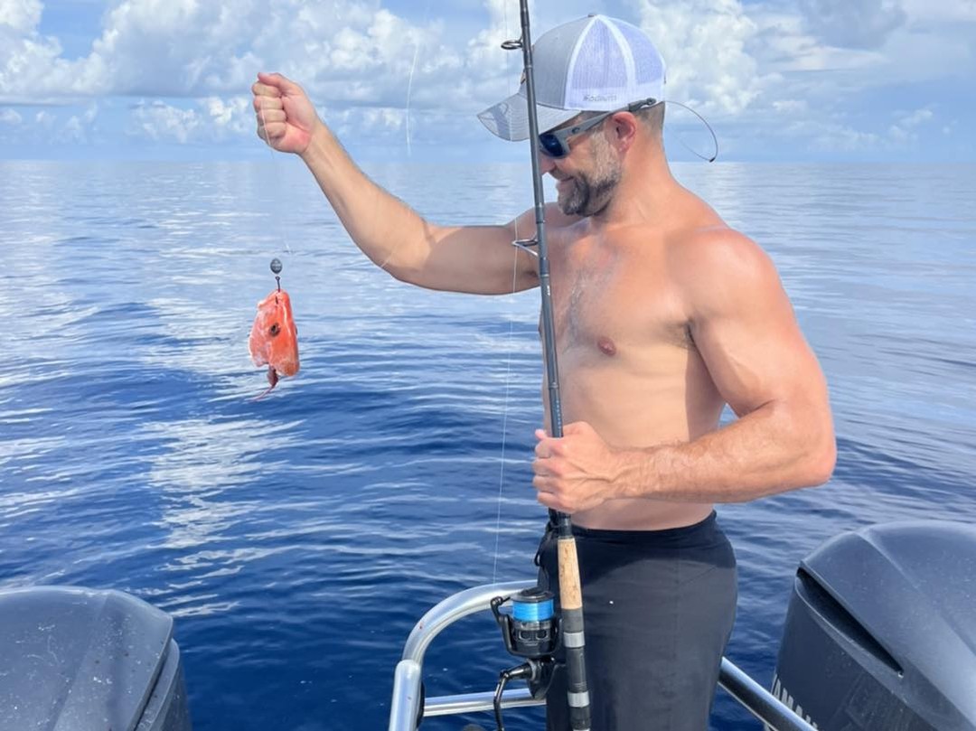 Freshly caught red fish being held up on fishing boat in Ocala FL waters