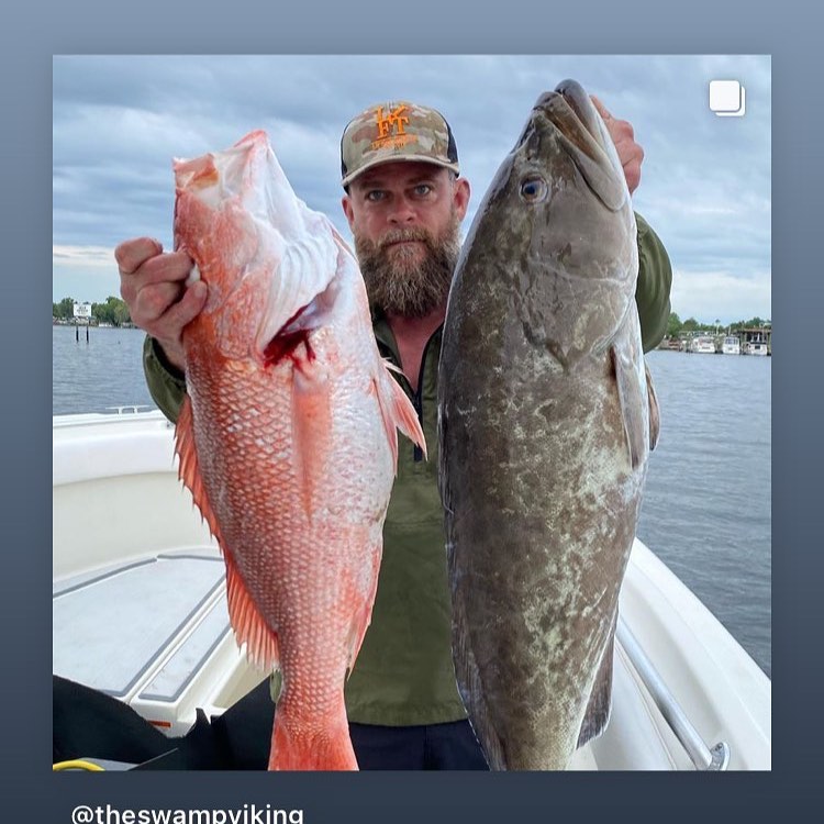 Angler displaying caught Red Snapper and Gag Grouper on fishing boat