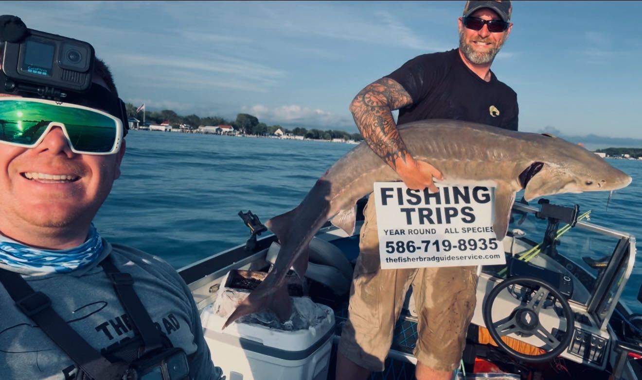 St Clair River sturgeon fishing charter boat with anglers catching lake sturgeon and walleye