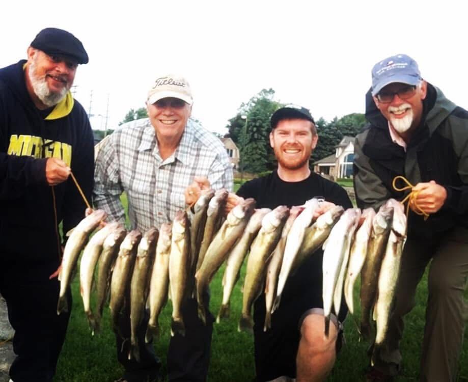 Walleye fishing charter boat on St. Clair River with fishing rods and tackle ready