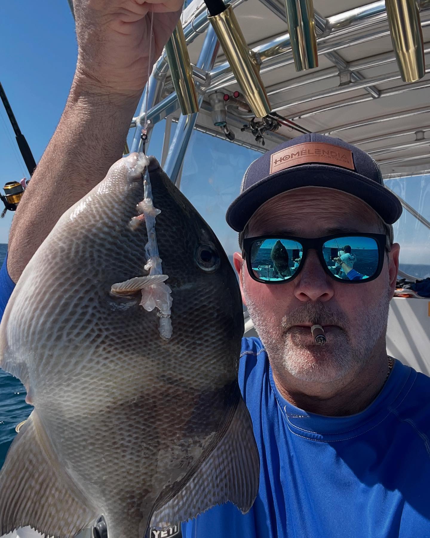 Angler holding a large grey triggerfish caught at Port Canaveral