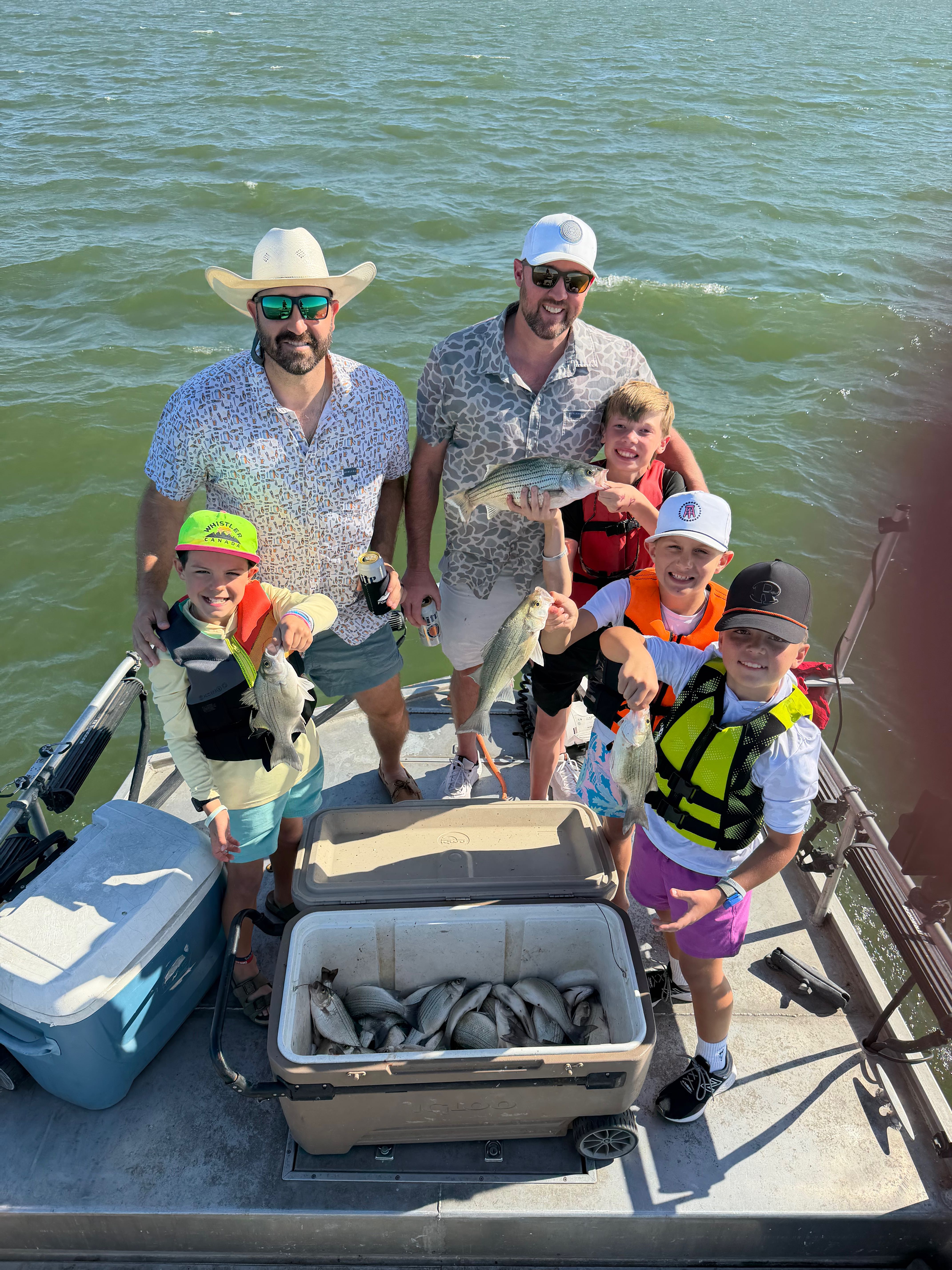 Successful fishing trip showing striped bass and white bass catch on boat in Forney TX