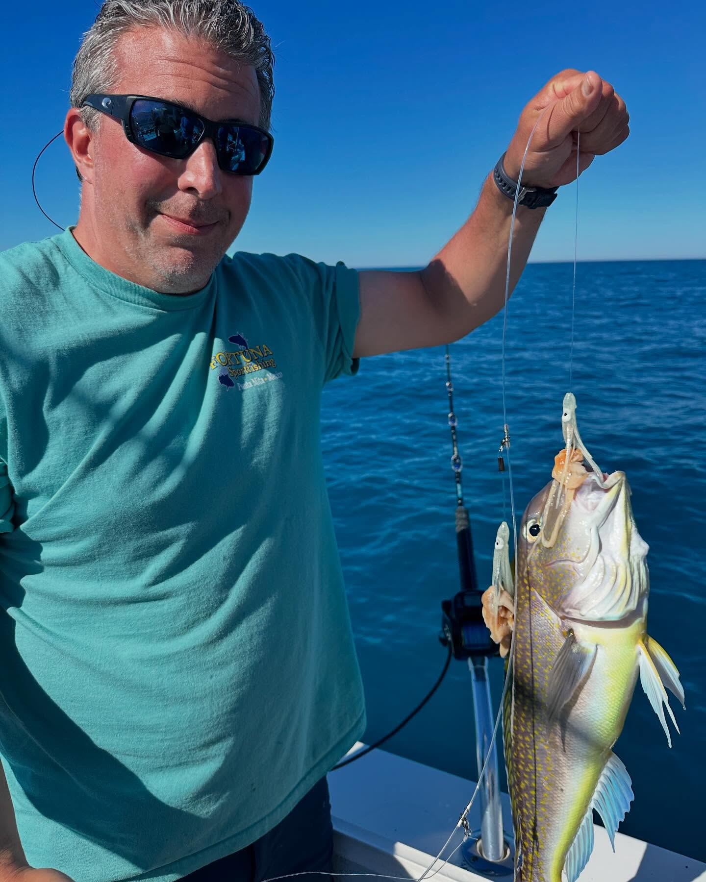 Fresh caught fish being held up on fishing boat in Neptune City NJ waters