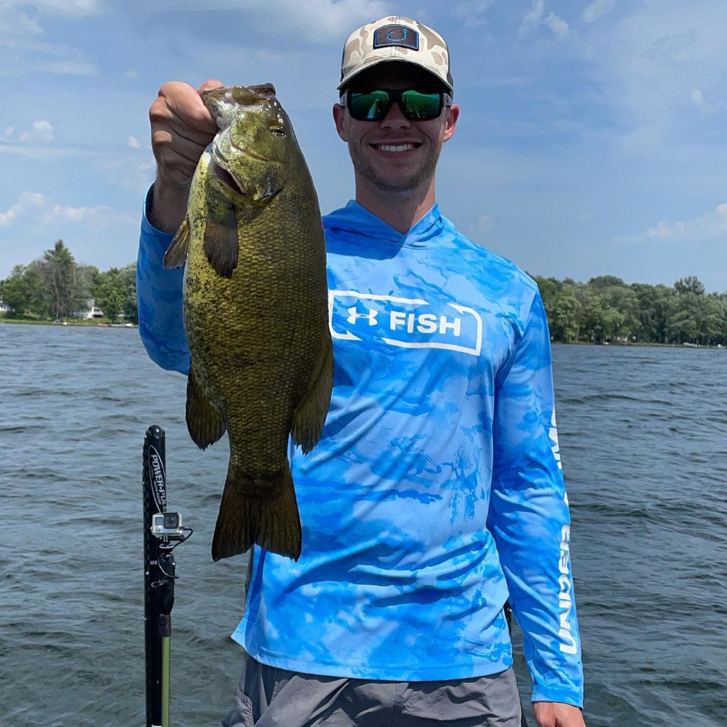 An angler posing with a large fish in Old Forge