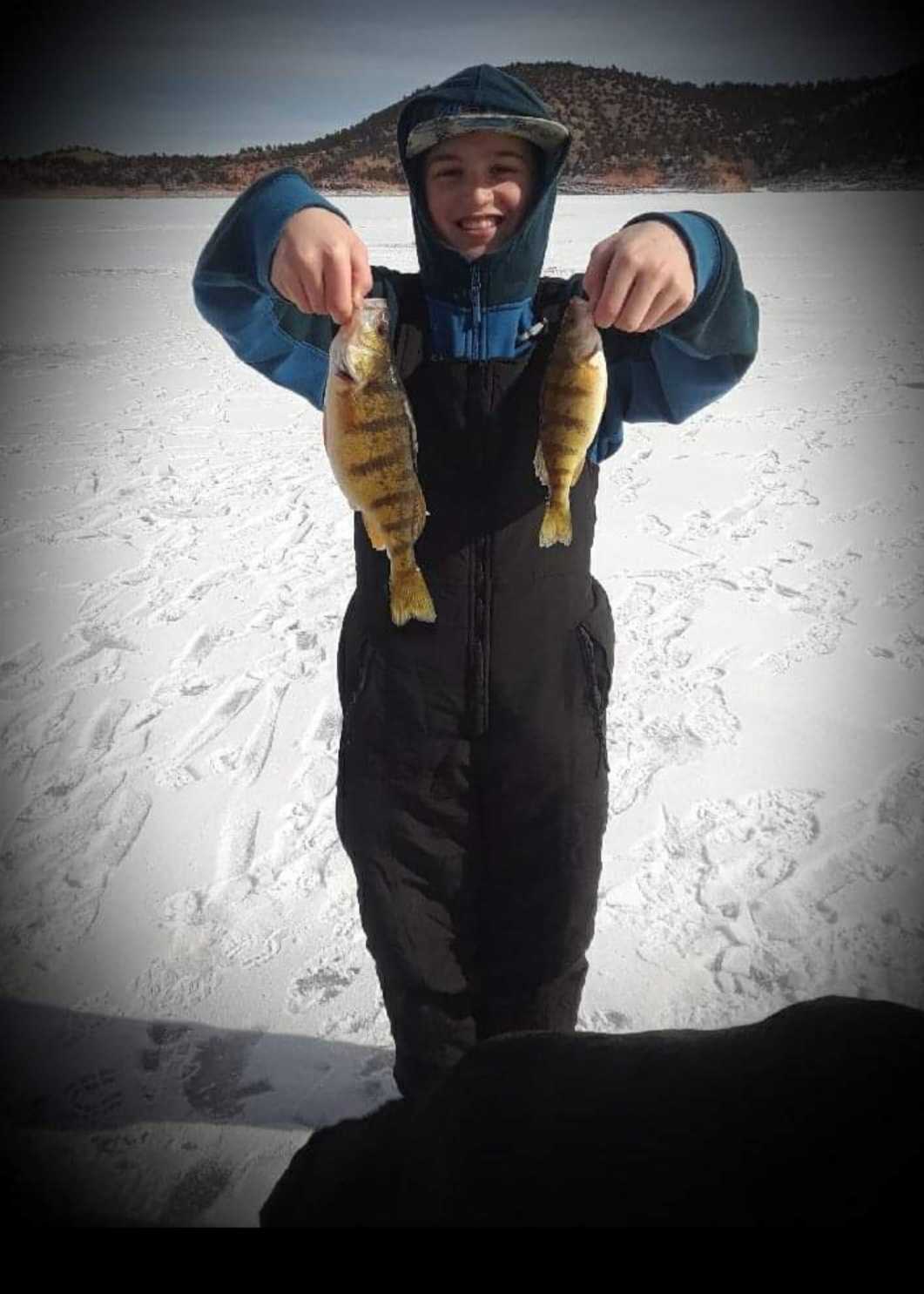 Two small fishing rods with a single person fishing in Douglas
