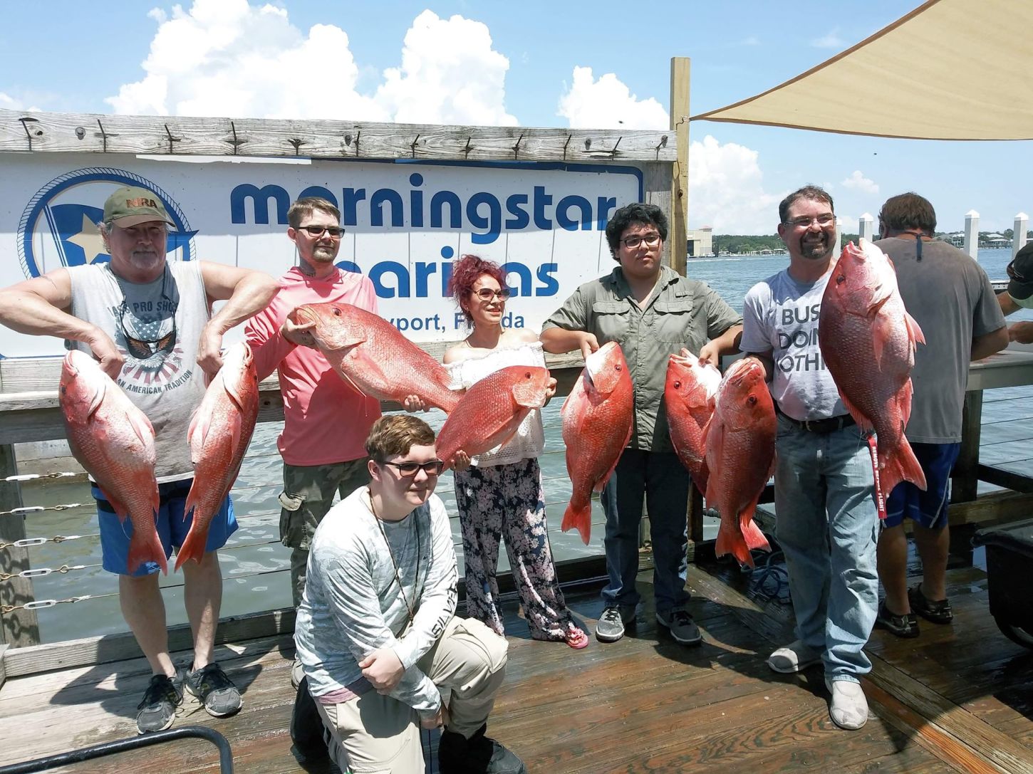 Large group of anglers posing with their impressive catch at Orange Park