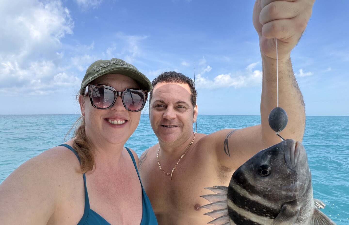 Fresh caught sheepshead fish being held up on fishing boat in Clearwater FL waters