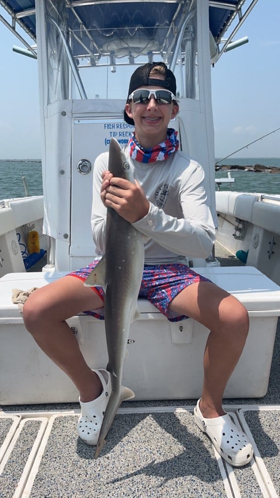 Fisherman holding a 26-inch Atlantic Sharpnose Shark in TX