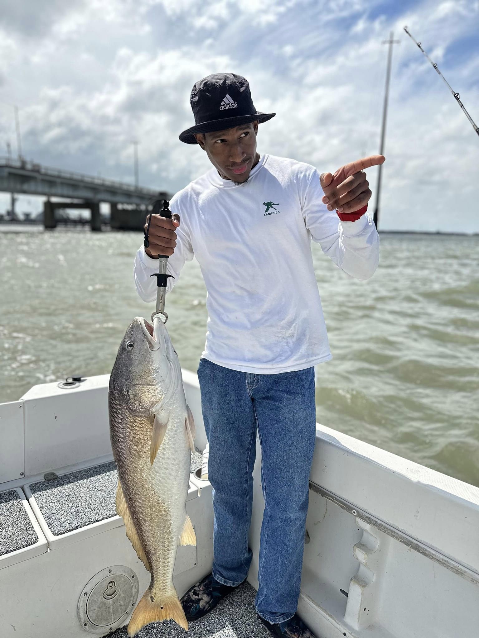 A fisherman holding a large redfish caught in Hitchcock