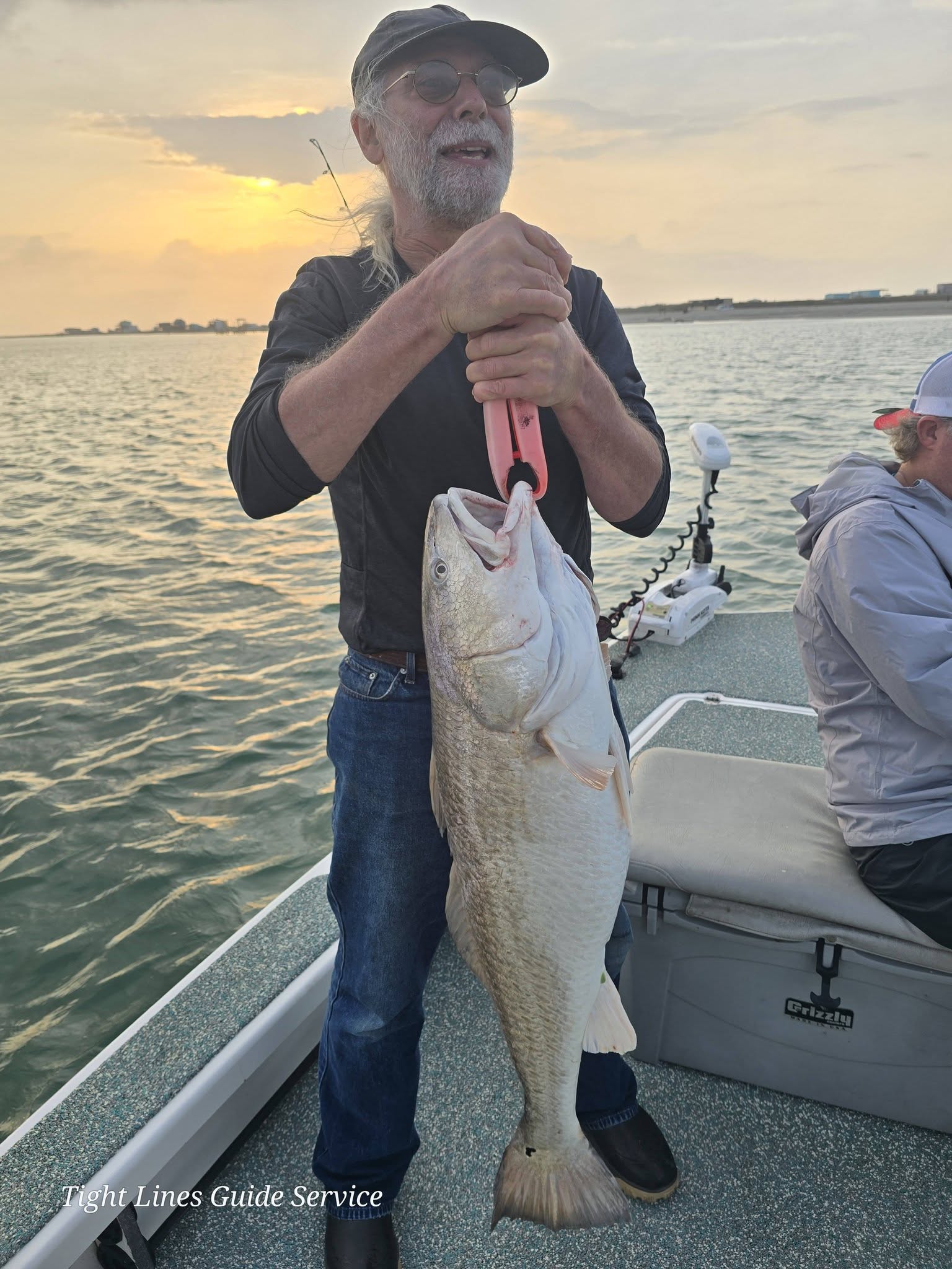 Large redfish caught on fishing boat at Point Comfort TX during sunset