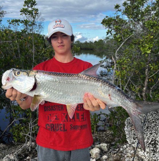 Angler landing a large tarpon in Miami