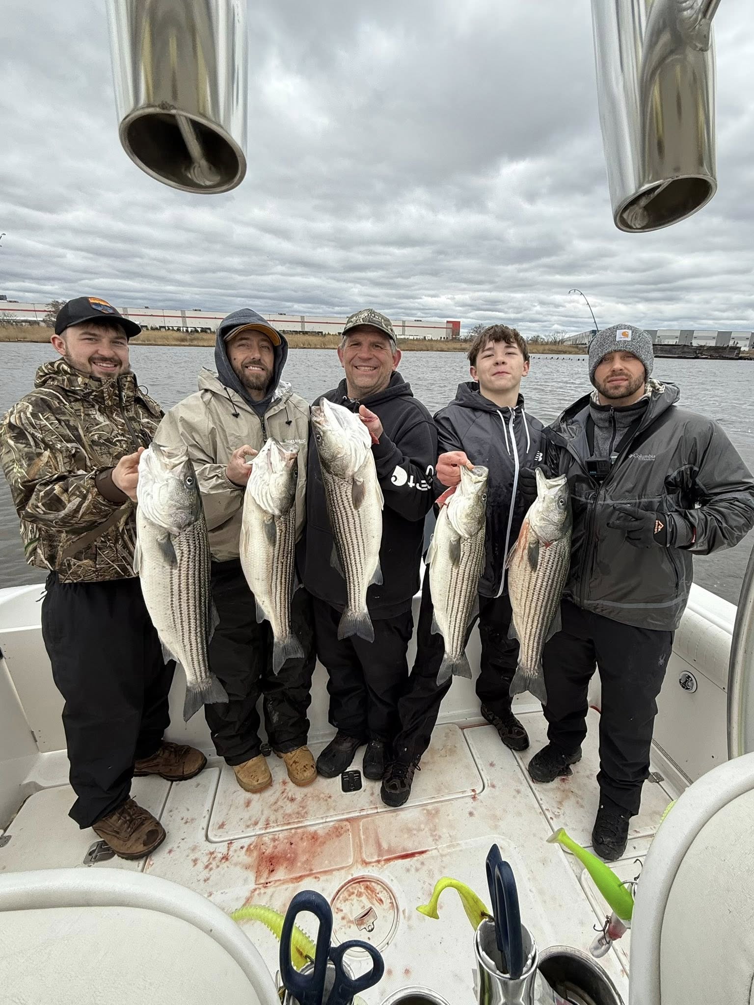 Five striped bass caught during fishing trip at Point Pleasant Beach NJ displayed on boat deck