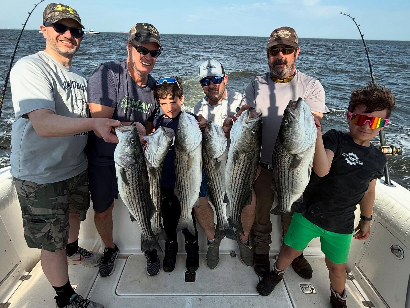 6-hour fall striped bass fishing charter boat on Long Island waters with fishing rods ready
