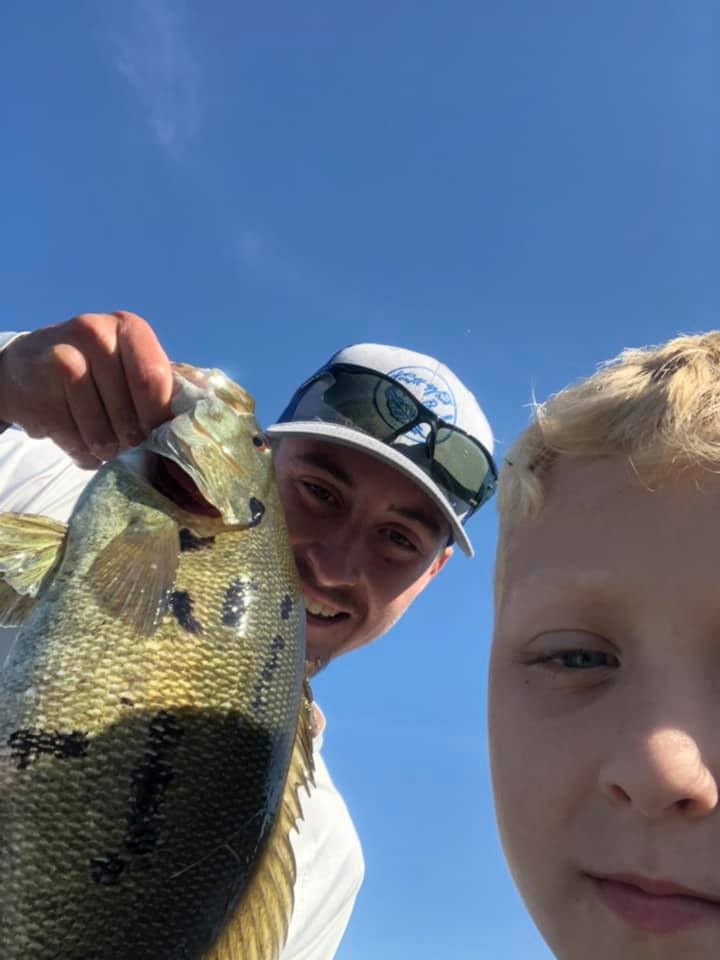 Two people fishing in New York with a single fish