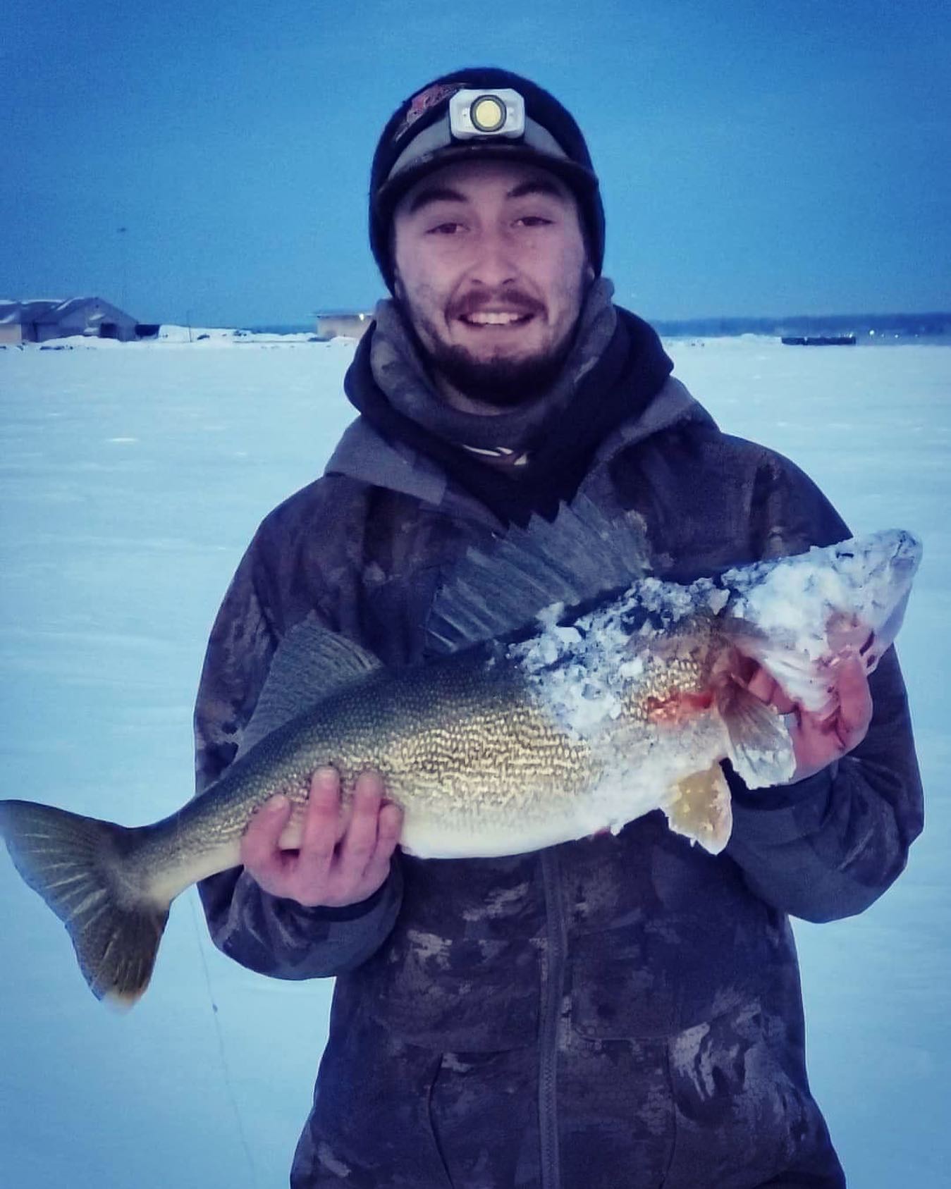Two people fishing in Ogdensburg with a 21-inch fish
