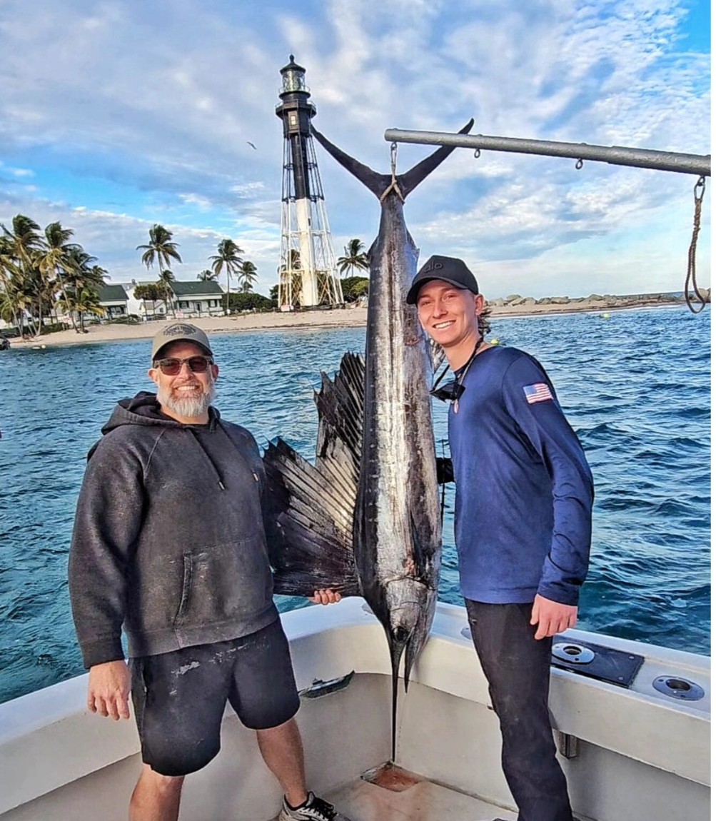 Atlantic sailfish catch displayed on fishing boat in Pompano Beach FL with lighthouse visible in background