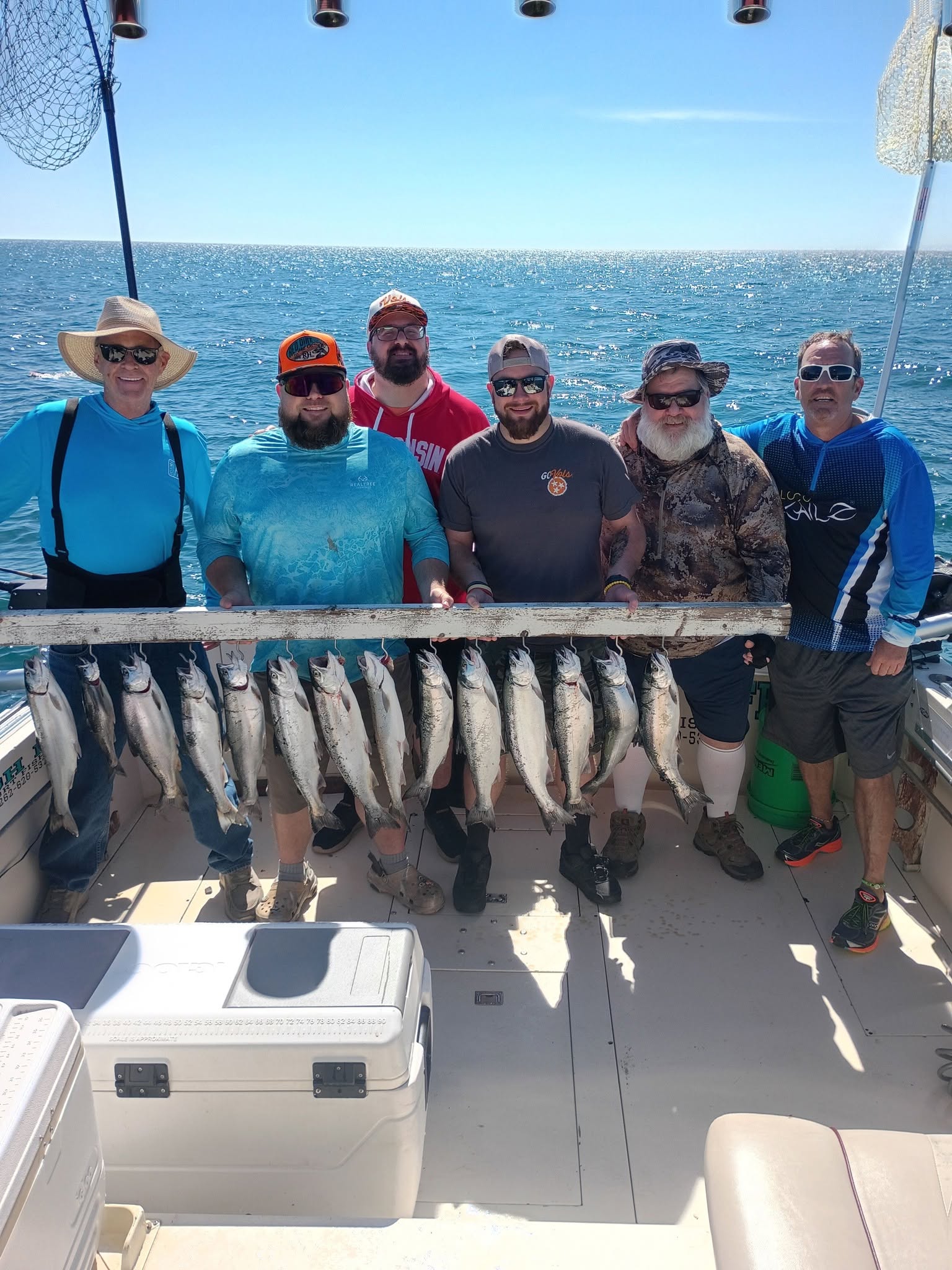 Successful fishing charter in Kenosha WI with multiple coho salmon displayed on boat deck