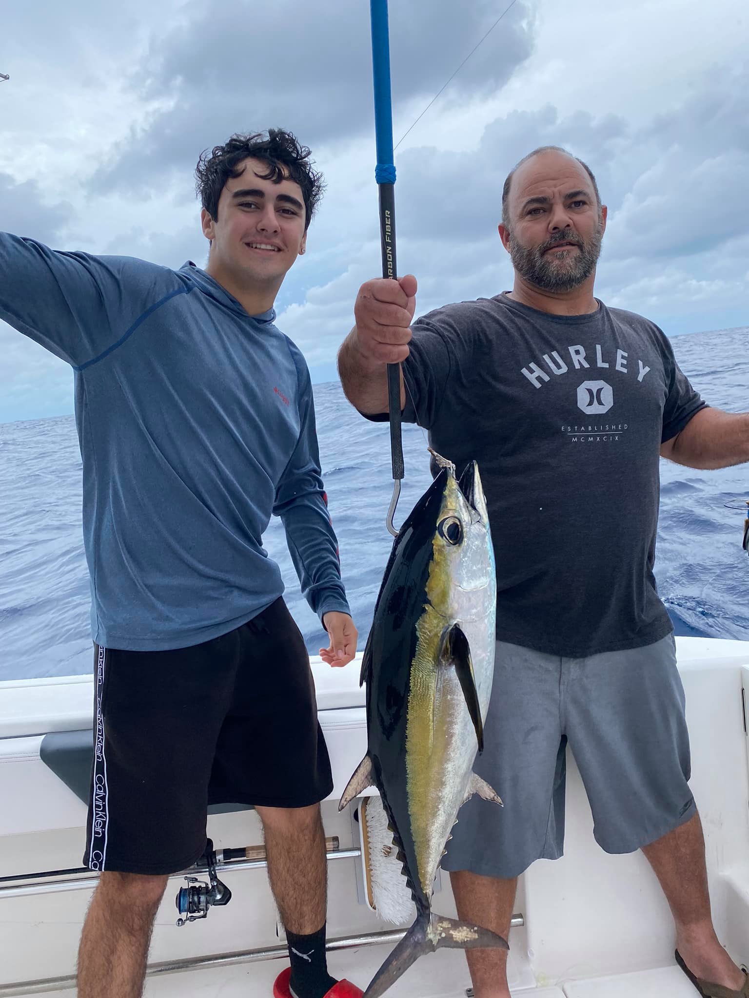 Two anglers hold a big 24-inch fish in FL