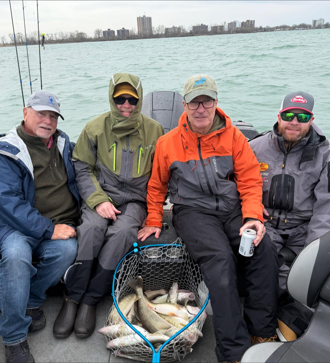 Fishing trip in Detroit MI with net full of caught fish on boat