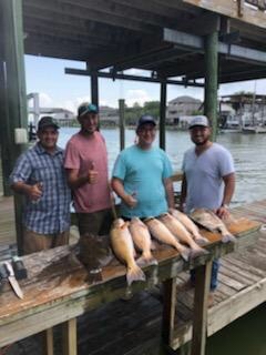 4 anglers holding their catch in Texas