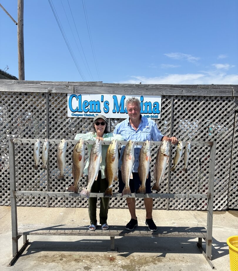 Fishing charter displaying catch of redfish at marina in Corpus Christi TX