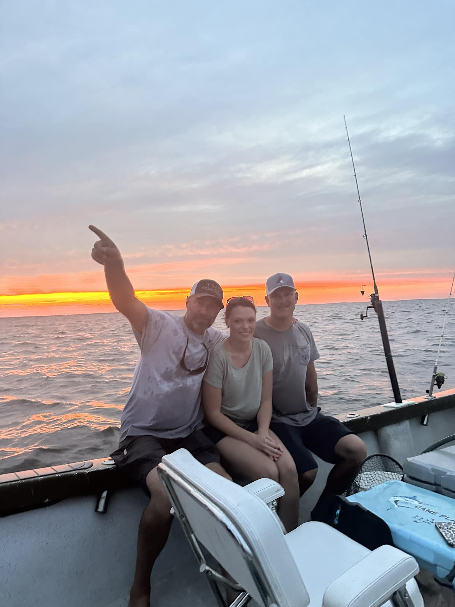 Fishing boat on ocean water at sunset in Morehead City NC with fishing rods
