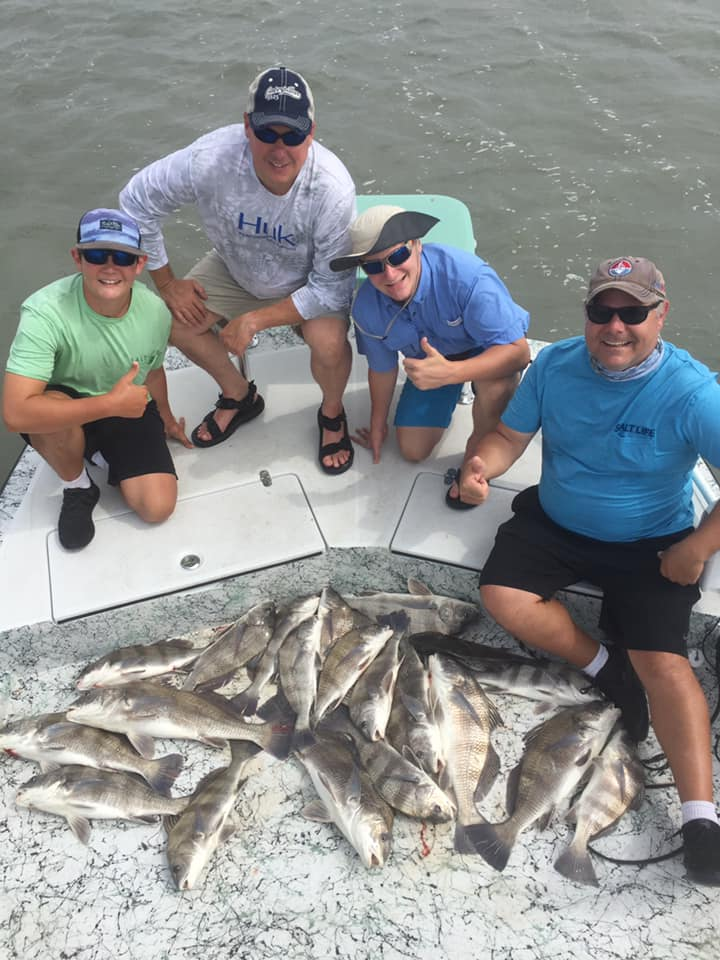 Two anglers catching fish in unknown location
