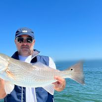Fisherman catching a 22-inch fish in St. Petersburg