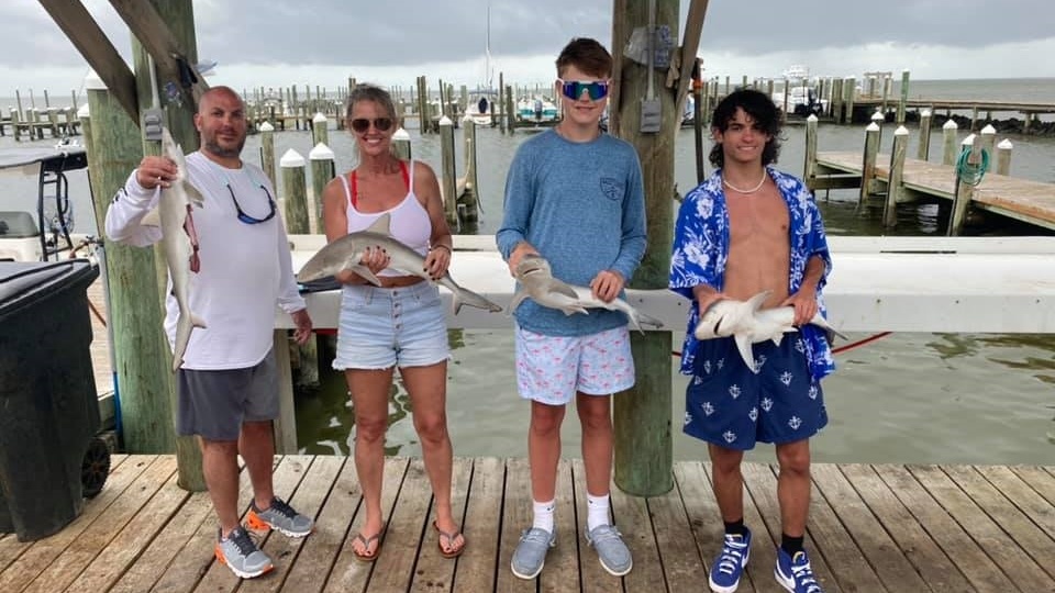 Four people enjoying a fishing trip in Gulf Shores