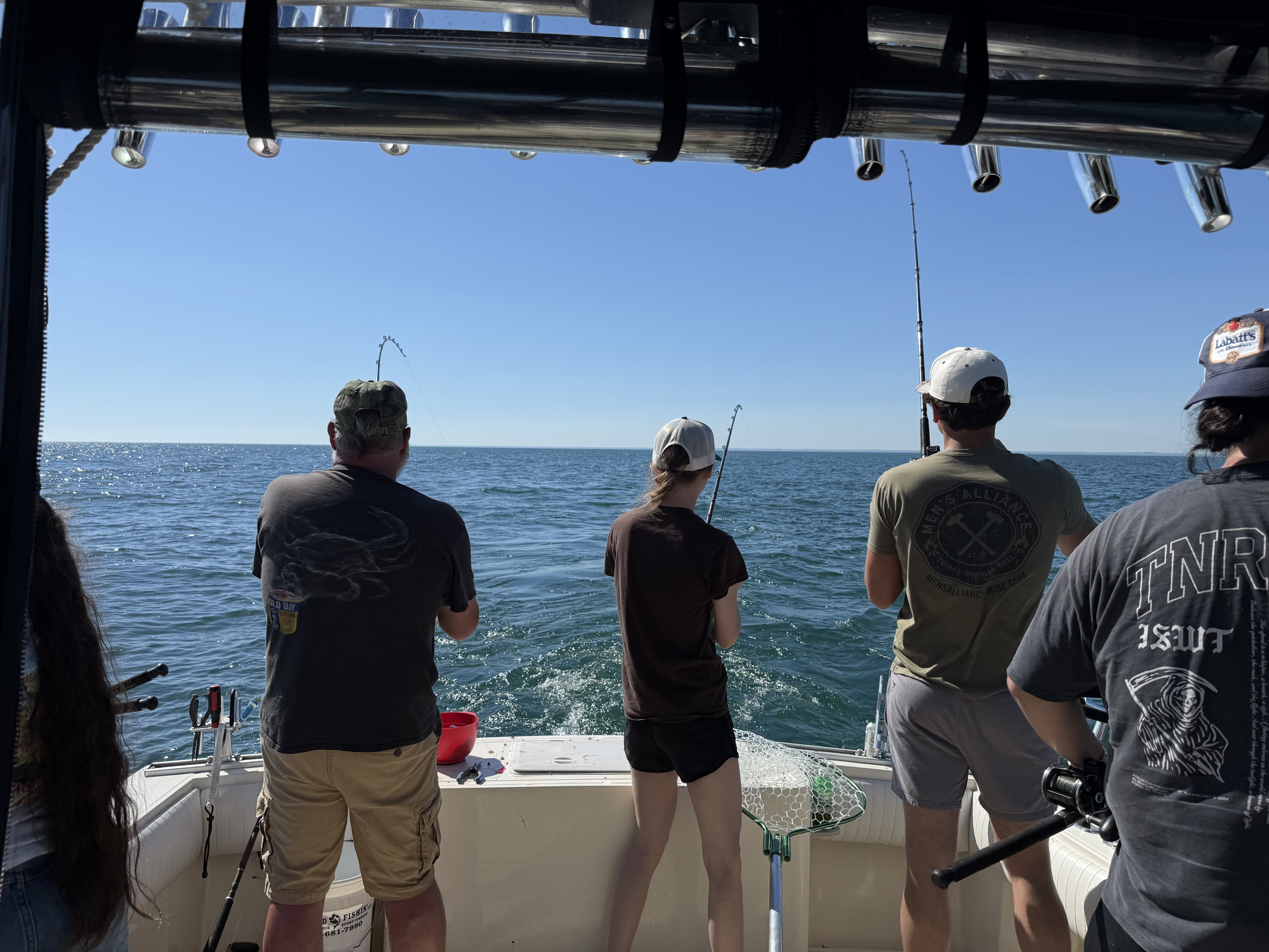 Fishing charter boat with multiple anglers casting lines into open water near Lakeside Marblehead OH