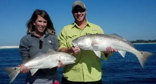Inshore fishing boat on calm Pensacola bay waters with Captain Tim's 6-passenger Kencraft vessel