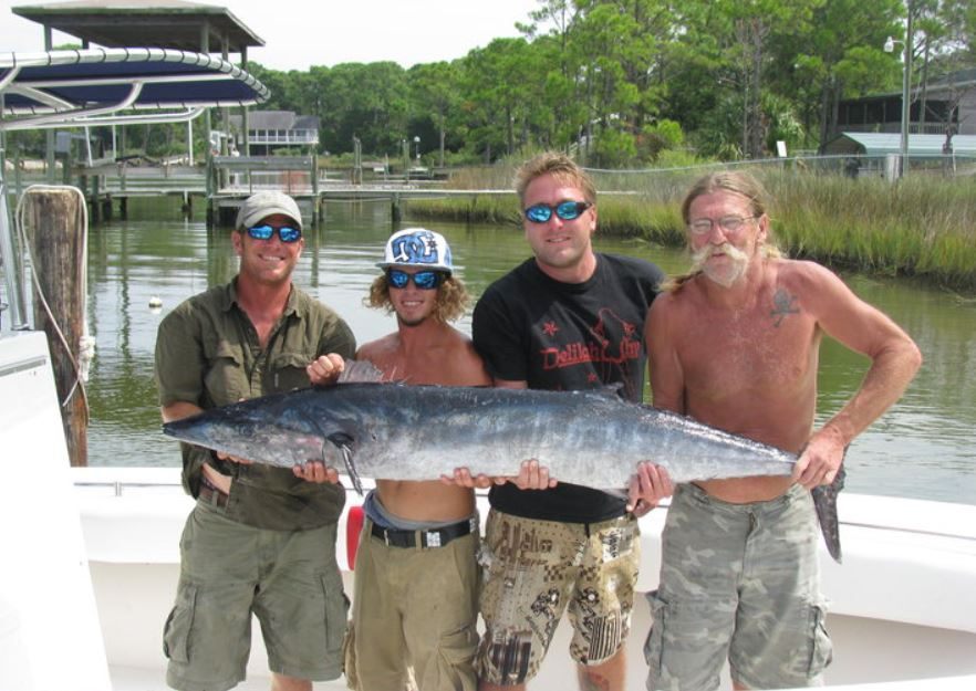A fisherman holding a large wahoo fish on St George Island