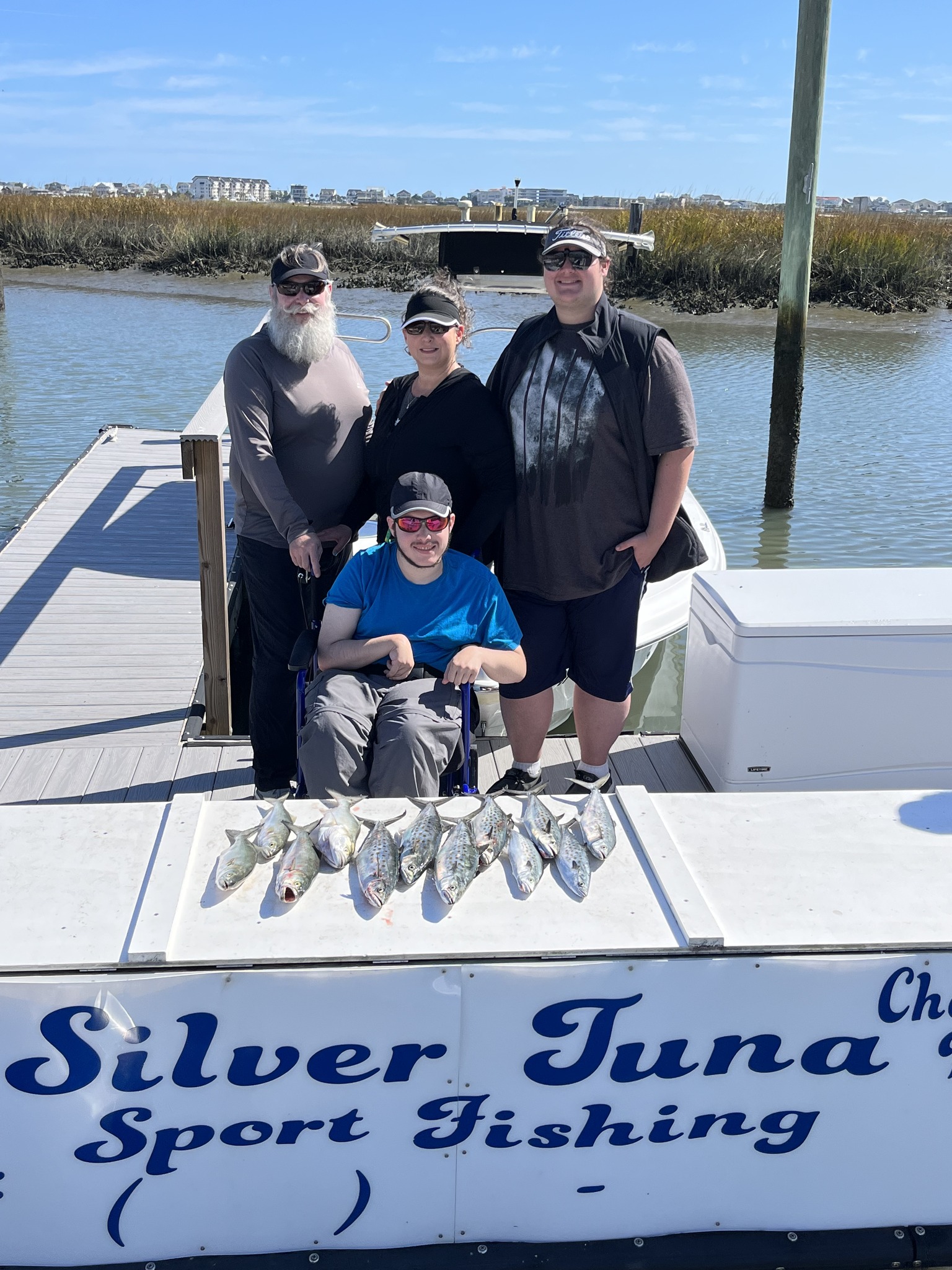 Four people enjoying a fishing trip in Murrells Inlet
