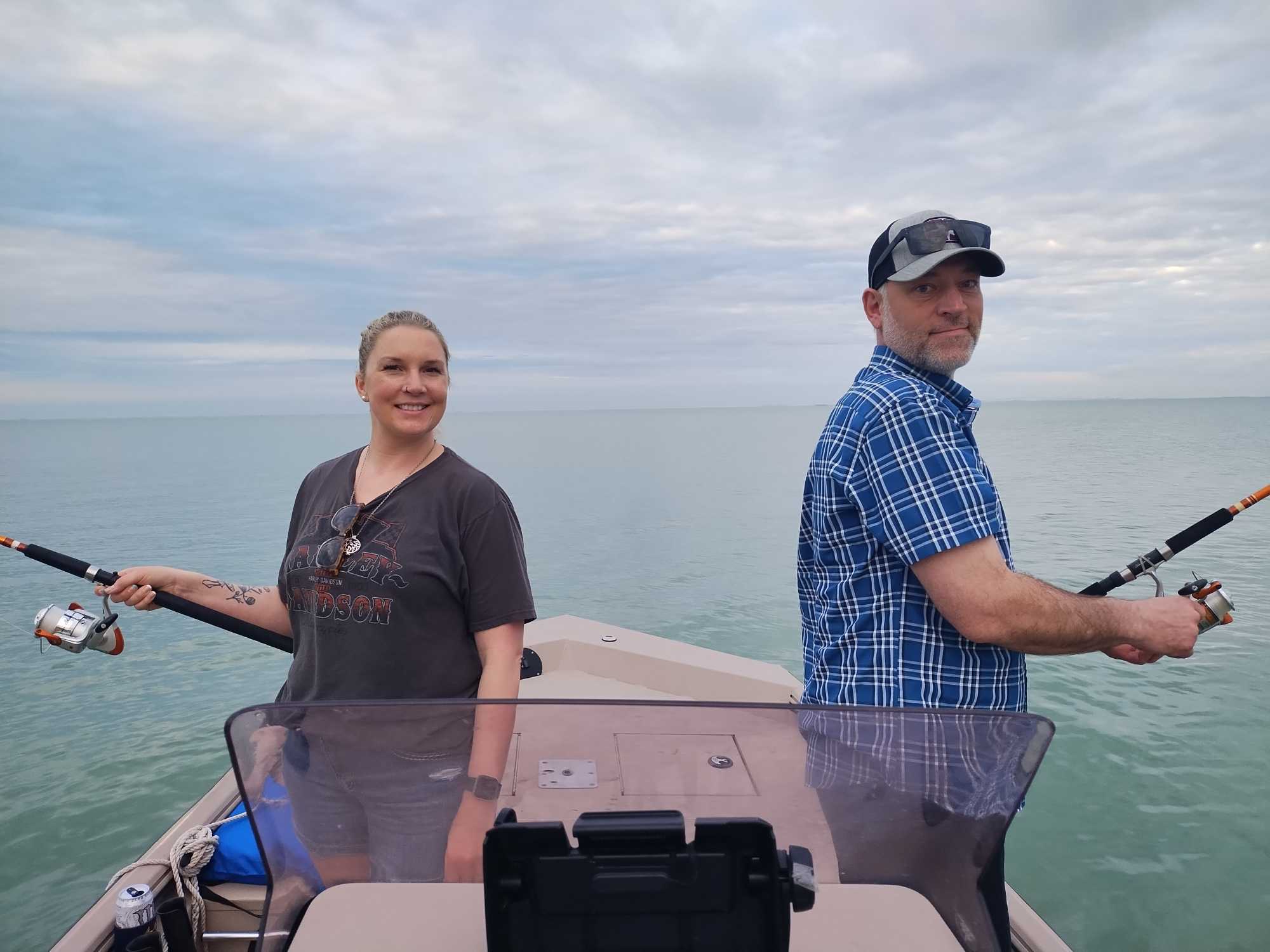 Two anglers fishing from boat on calm waters in Corpus Christi TX