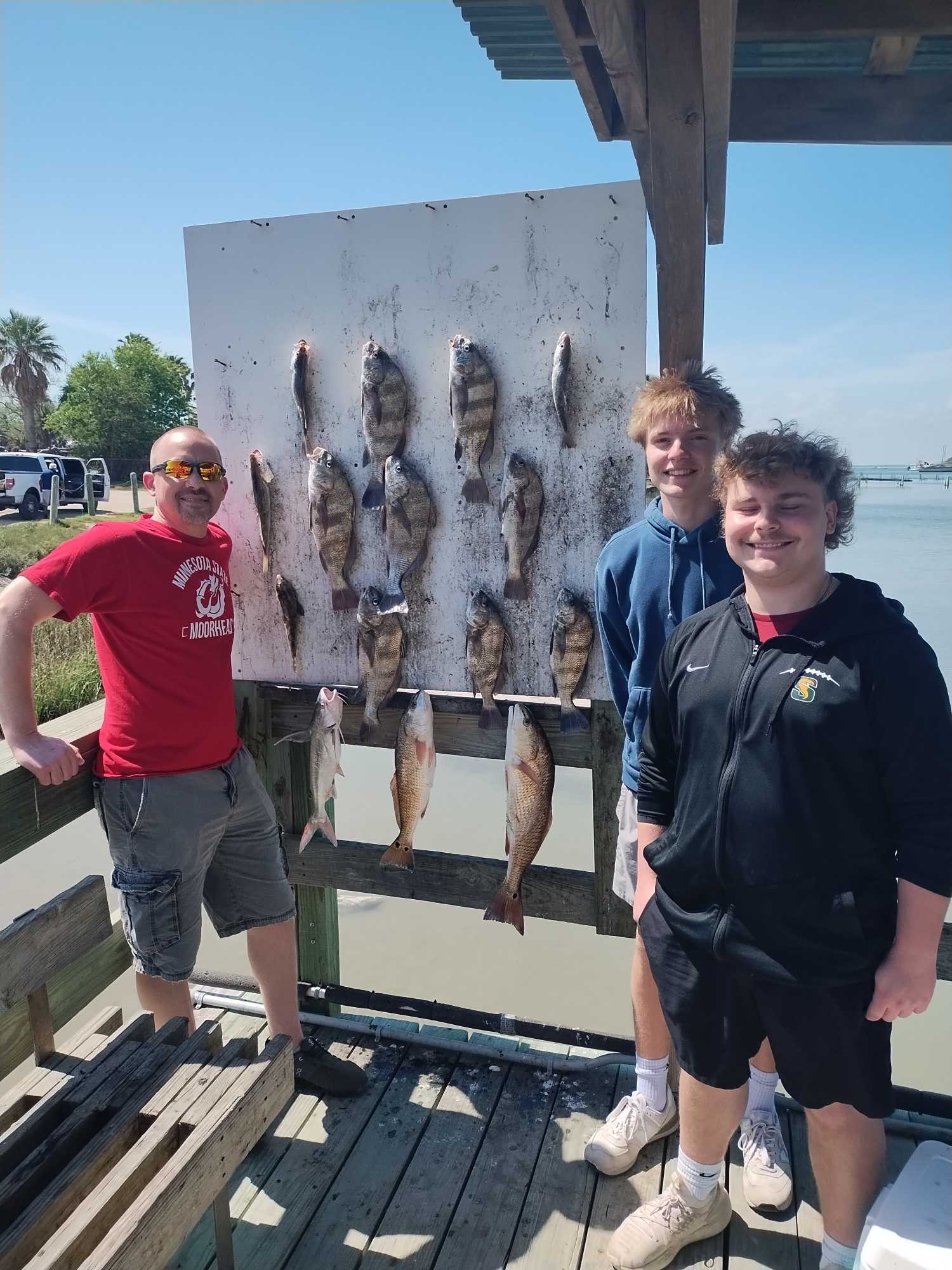Successful redfish fishing trip in Corpus Christi TX with multiple fish displayed on cleaning station