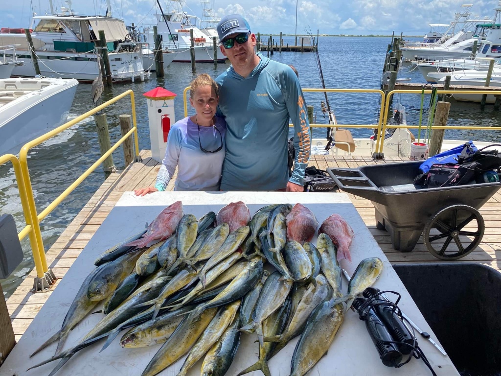 Two people with a 13-inch fish in Pensacola