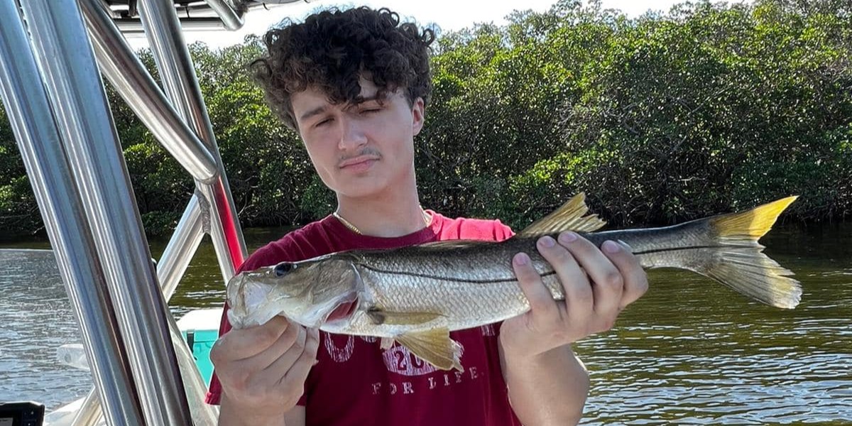 Tampa Bay inshore fishing charter boat with anglers catching snook and redfish on 6-hour trip