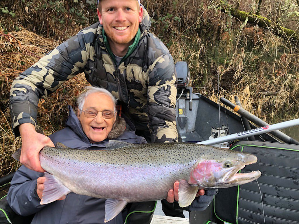 Angler with a large rainbow trout caught while fishing in Roseburg