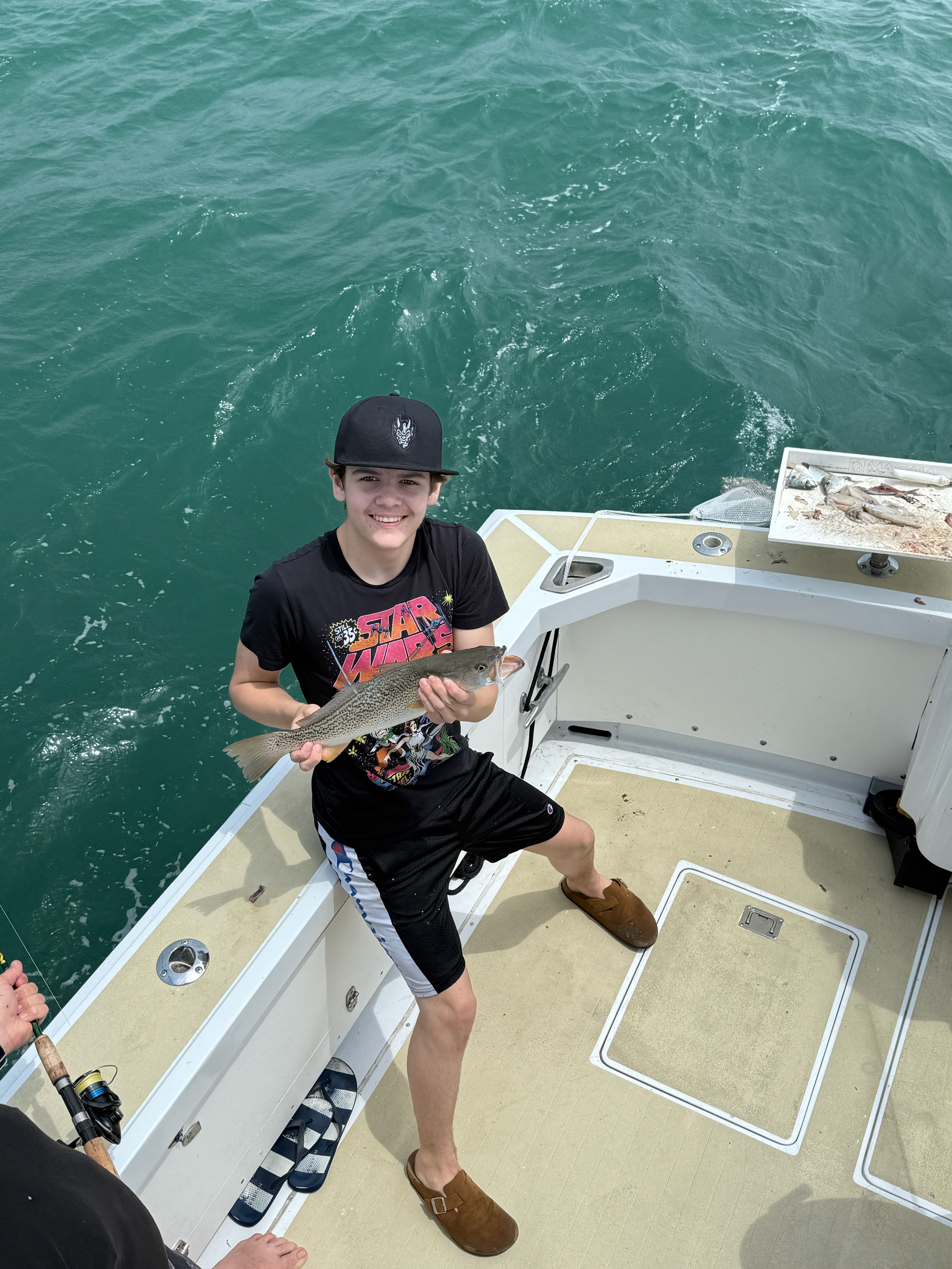 Fisherman catching a 14-inch fish in NC