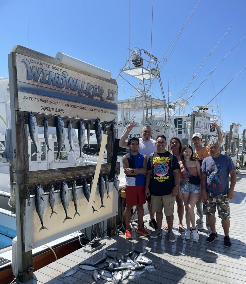 Successful fishing charter in Destin FL showing multiple fish species displayed on dock