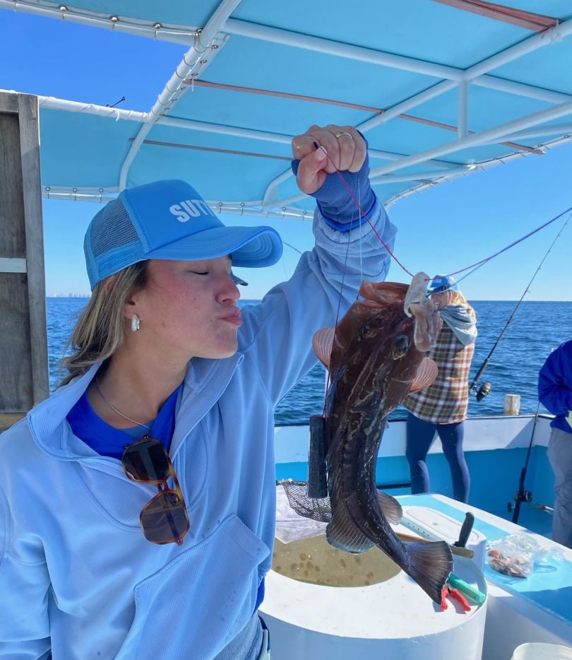 Fresh caught grouper fish held up on fishing boat in Destin FL waters