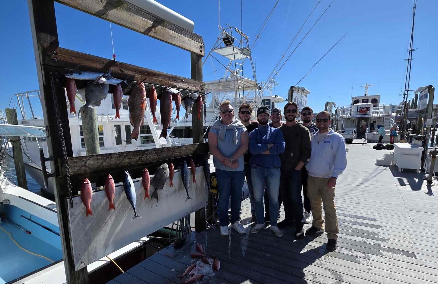 Fresh caught red grouper and other fish displayed on charter boat dock in Destin FL