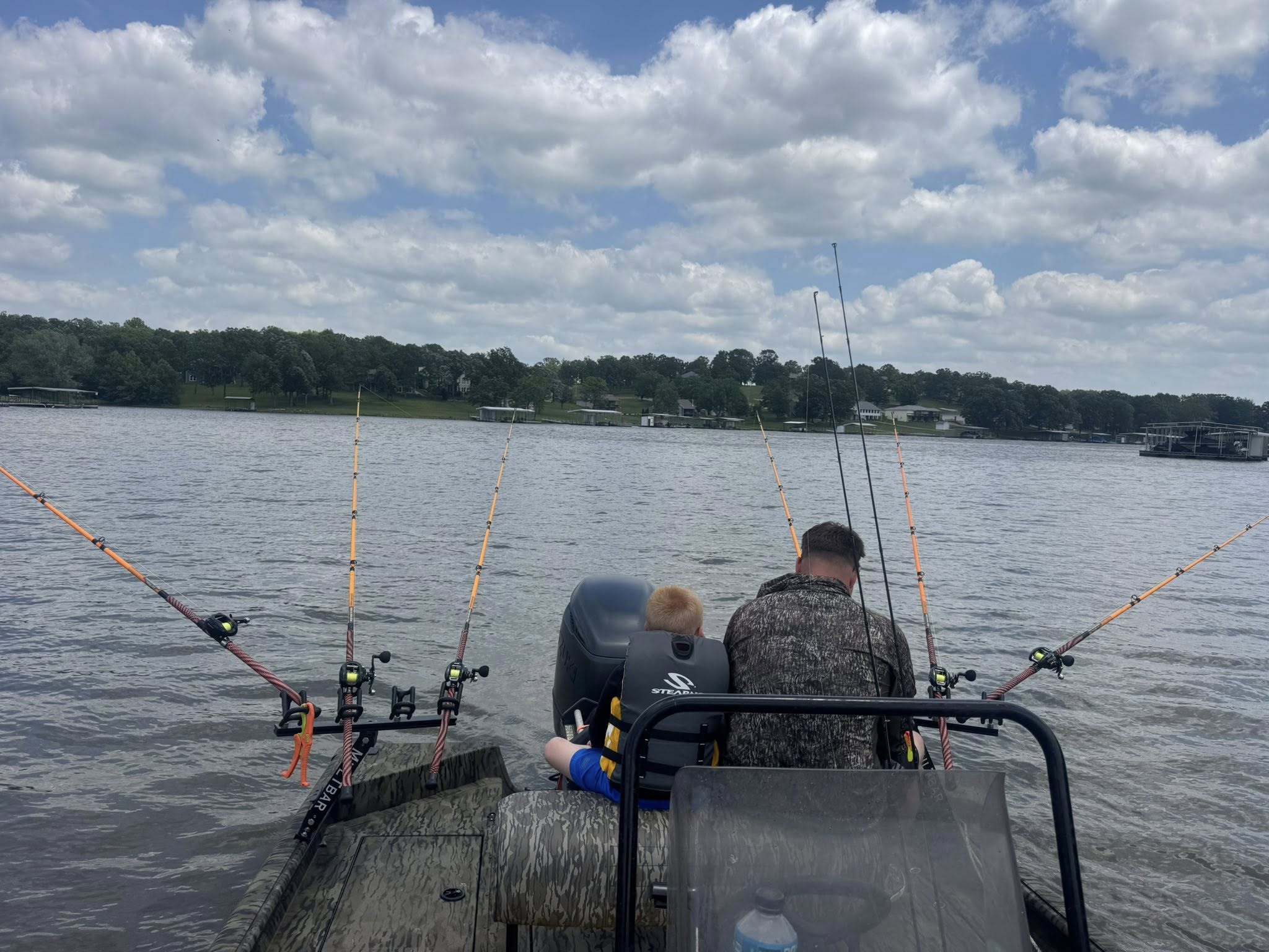 Modern fishing boat on Truman Lake with passengers enjoying summer charter guided trip