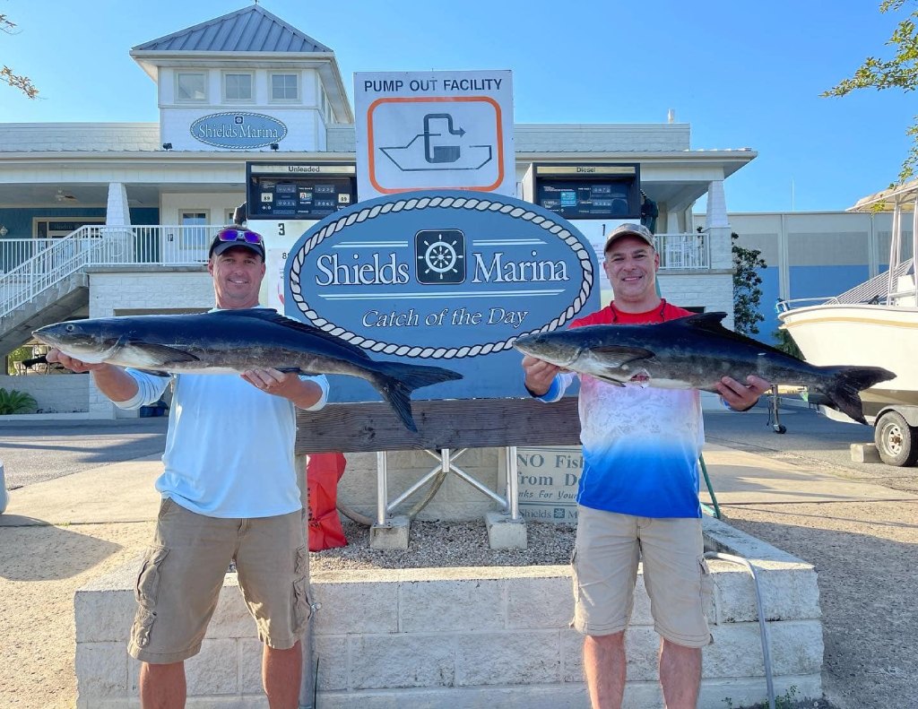 2 people fishing in FL with 2 big fish