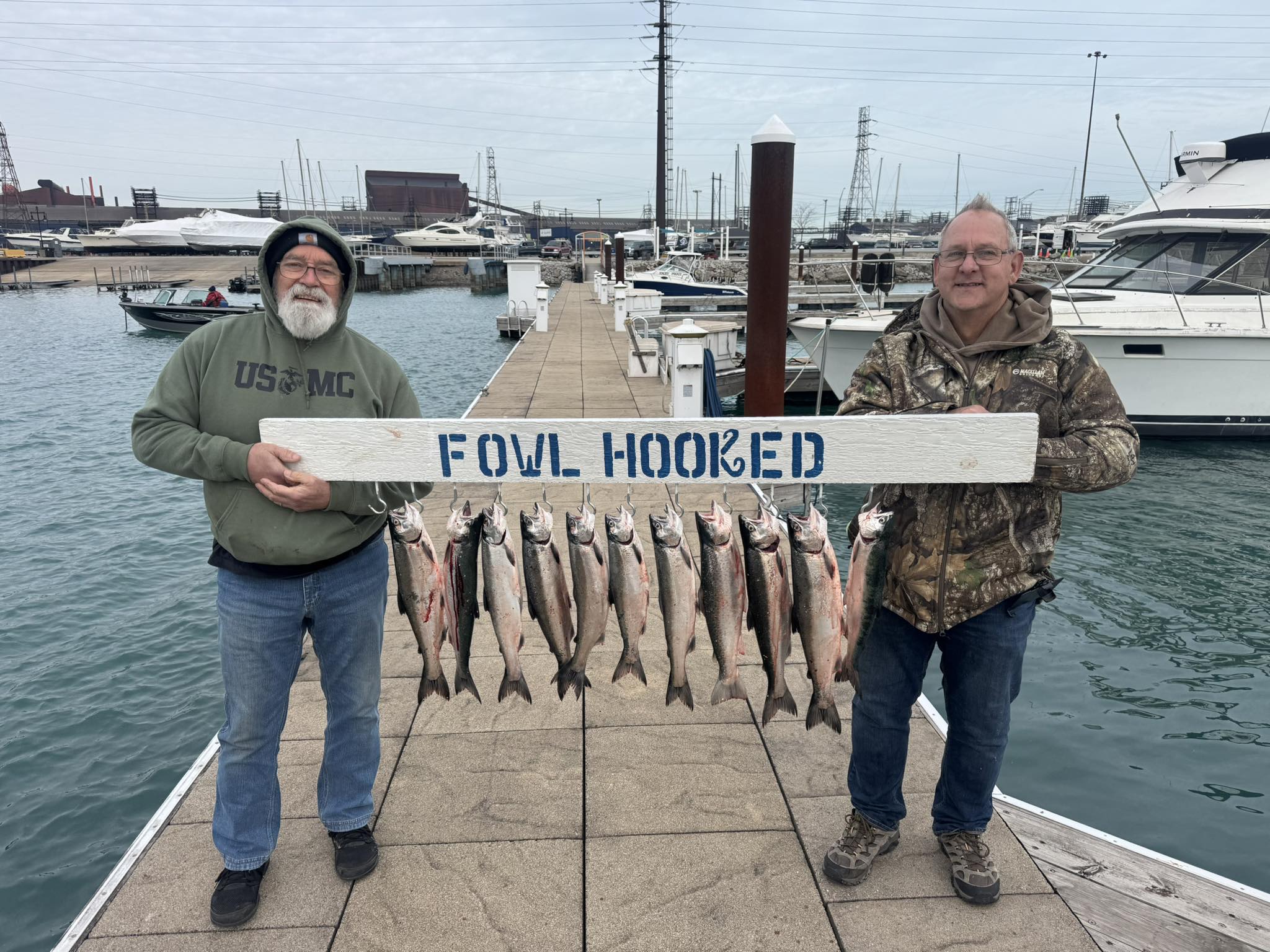 Successful fishing trip displaying multiple Coho Salmon catch on marina dock in East Chicago IN