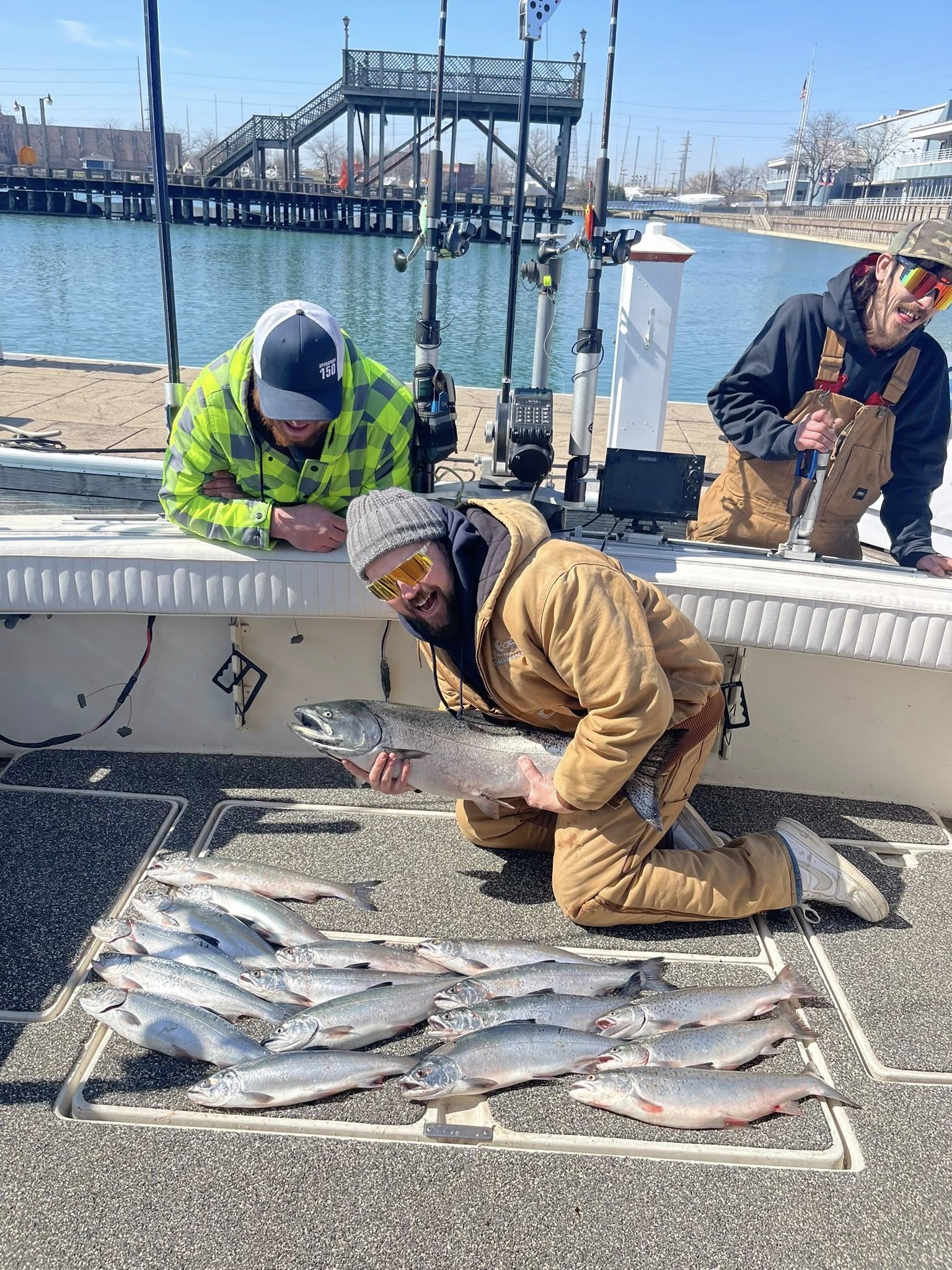 Successful fishing trip displaying multiple salmon species including Chinook and Sockeye salmon on boat deck in East Chicago IN