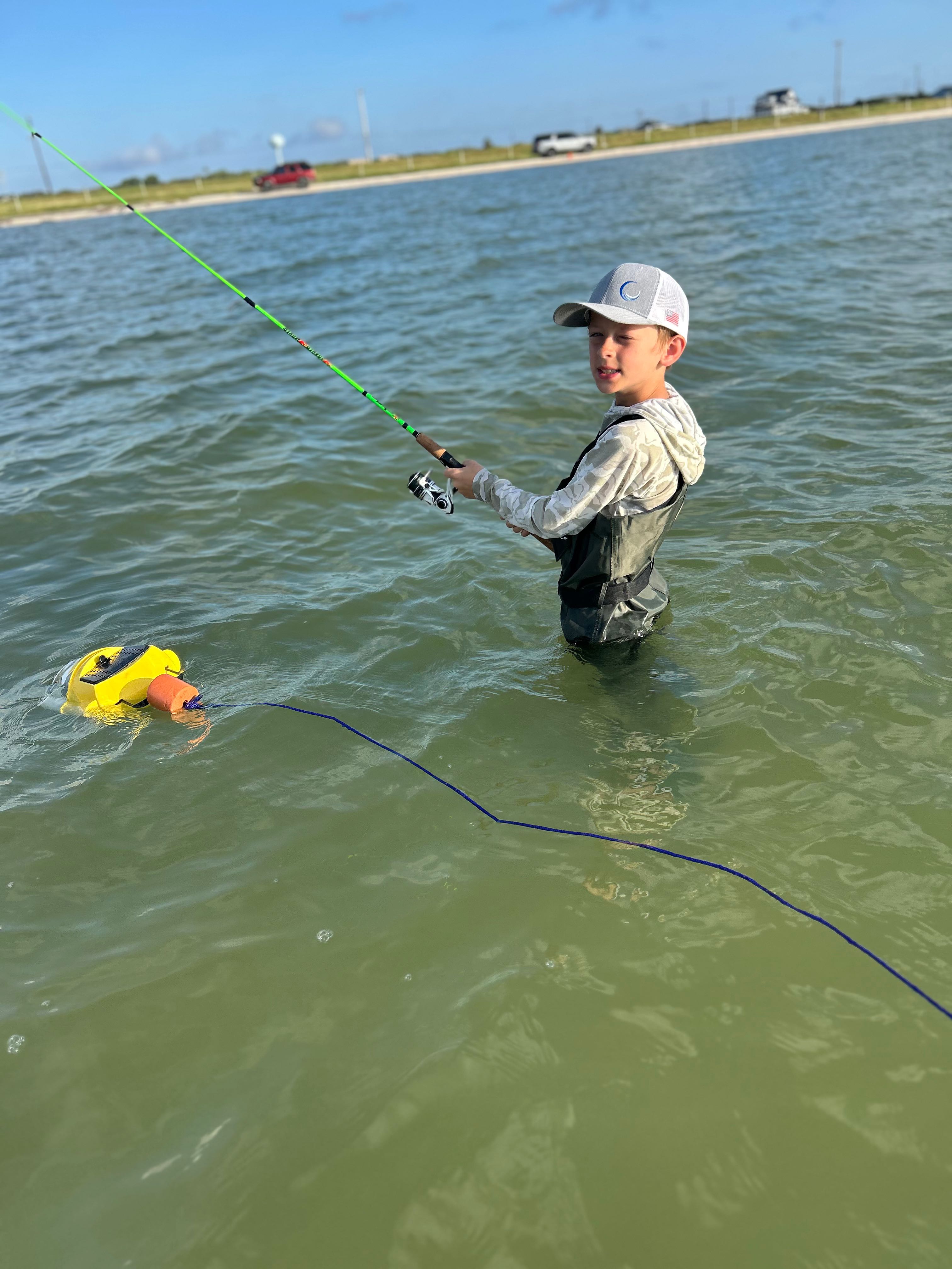 Wade fishing in shallow water at Rockport TX with fishing rod and float equipment