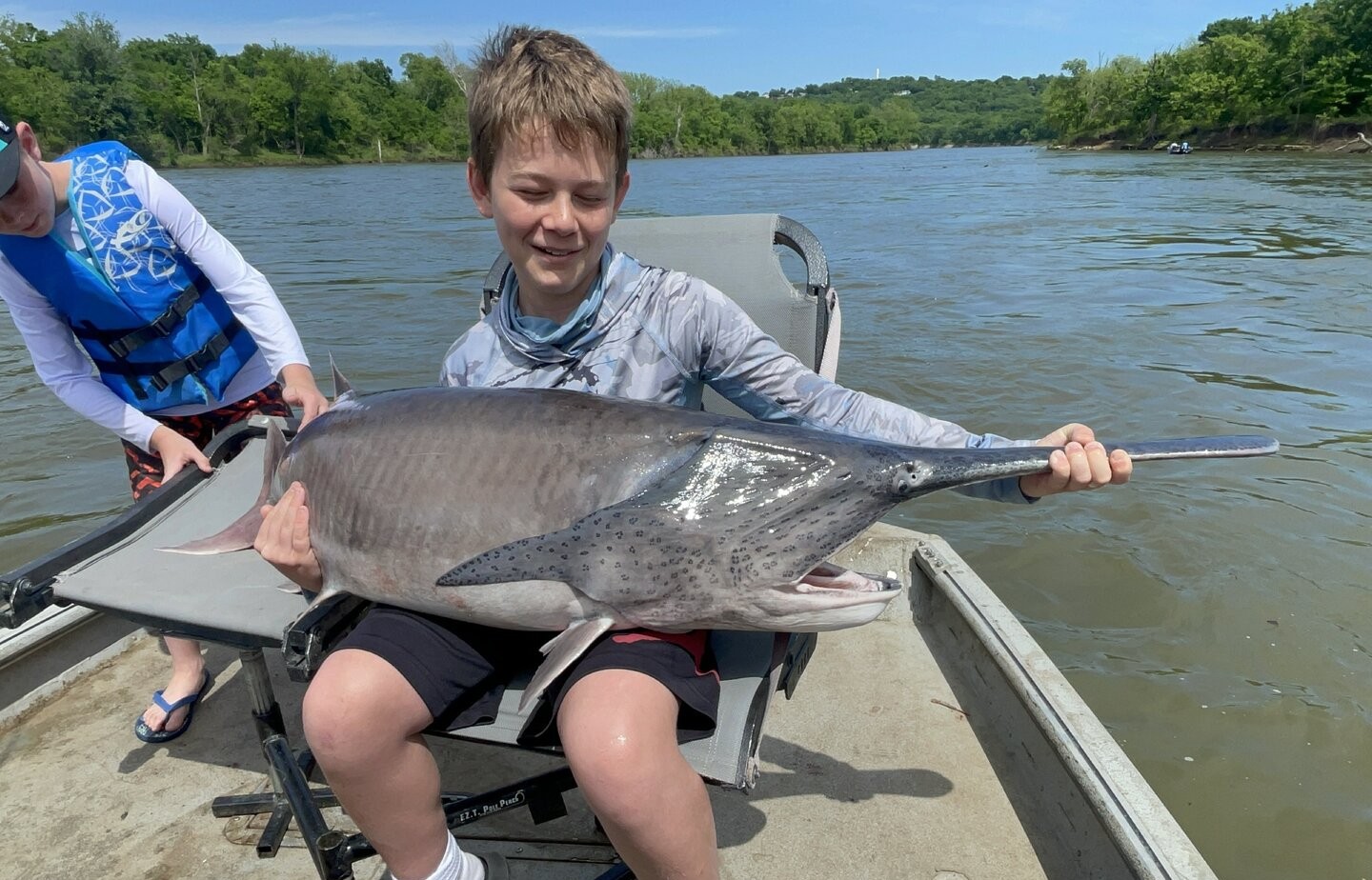 Large freshwater fish catch displayed on chair at Sand Springs OK riverbank