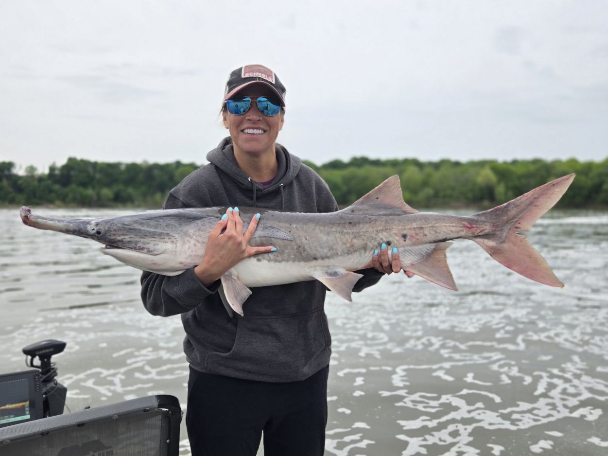 Angler holding large fish catch on boat in Sand Springs OK